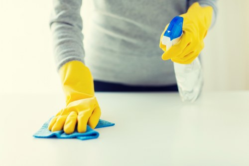 Cleaner wearing PPE while handling carpet cleaning equipment